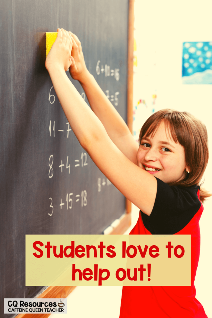 student erasing the chalkboard as she helps out her teacher